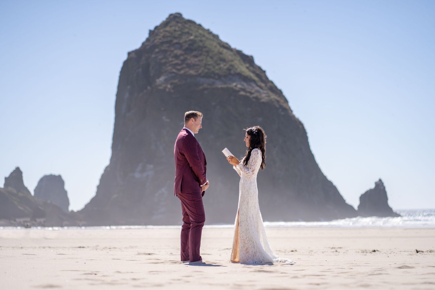 A romantic beach photo shoot with Haystack Rock at Cannon Beach Oregon in the background.