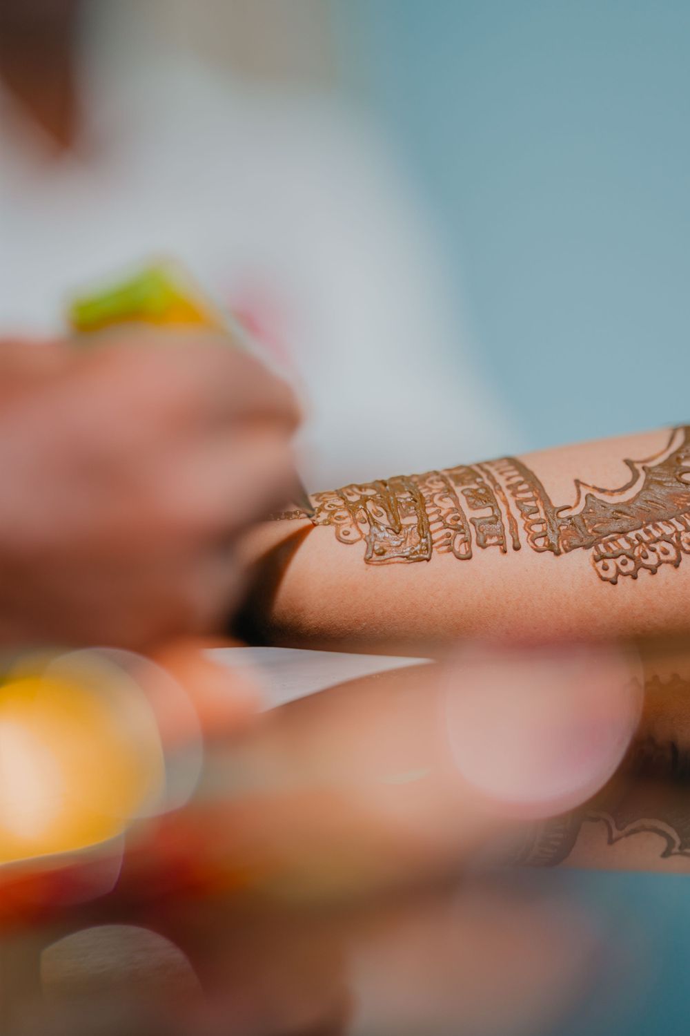 Intricate henna design adorning an arm with beautiful traditional mehndi patterns.