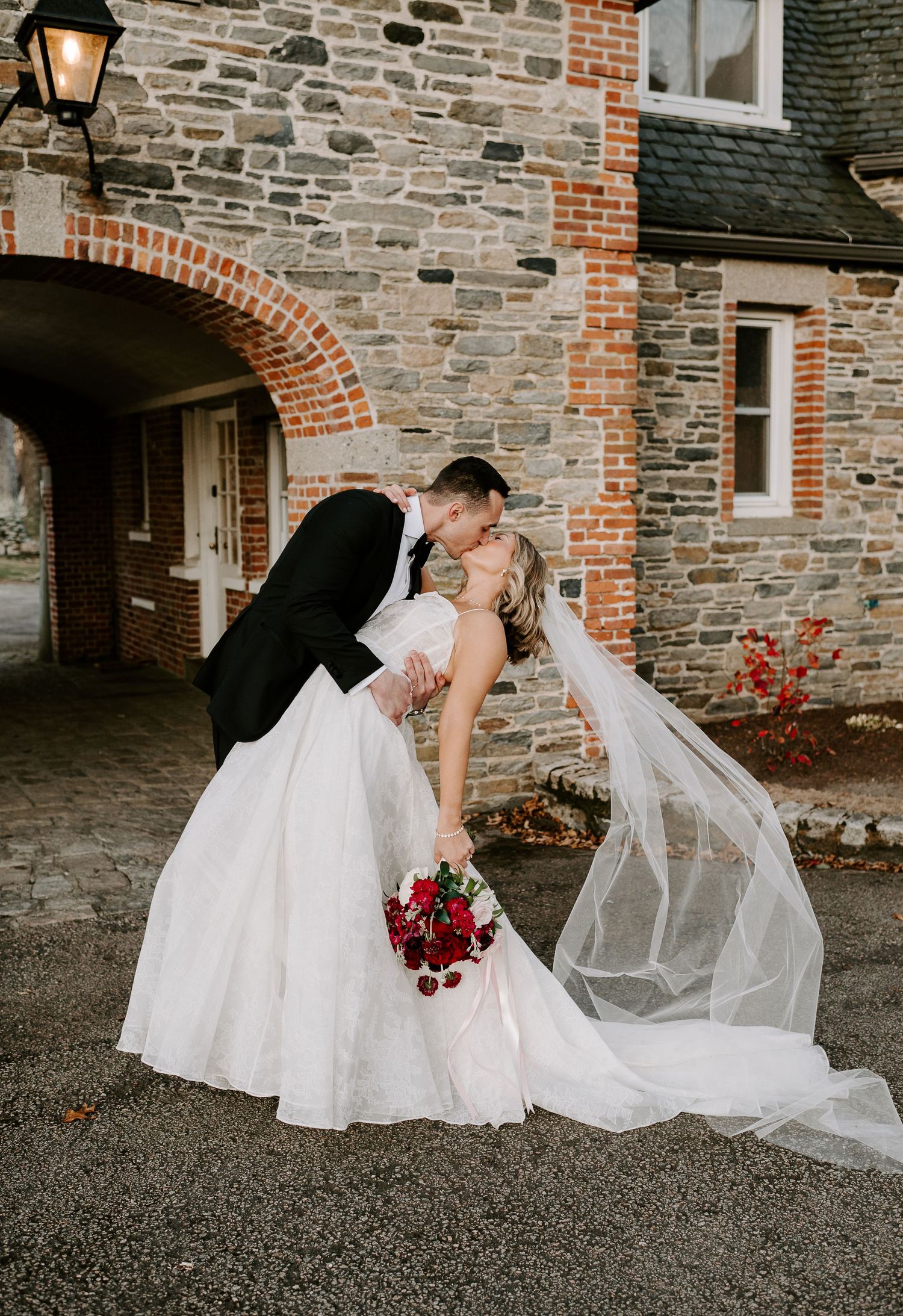 Series of wedding photos showing a playful moment with a bride's flowing veil against a brick building exterior.