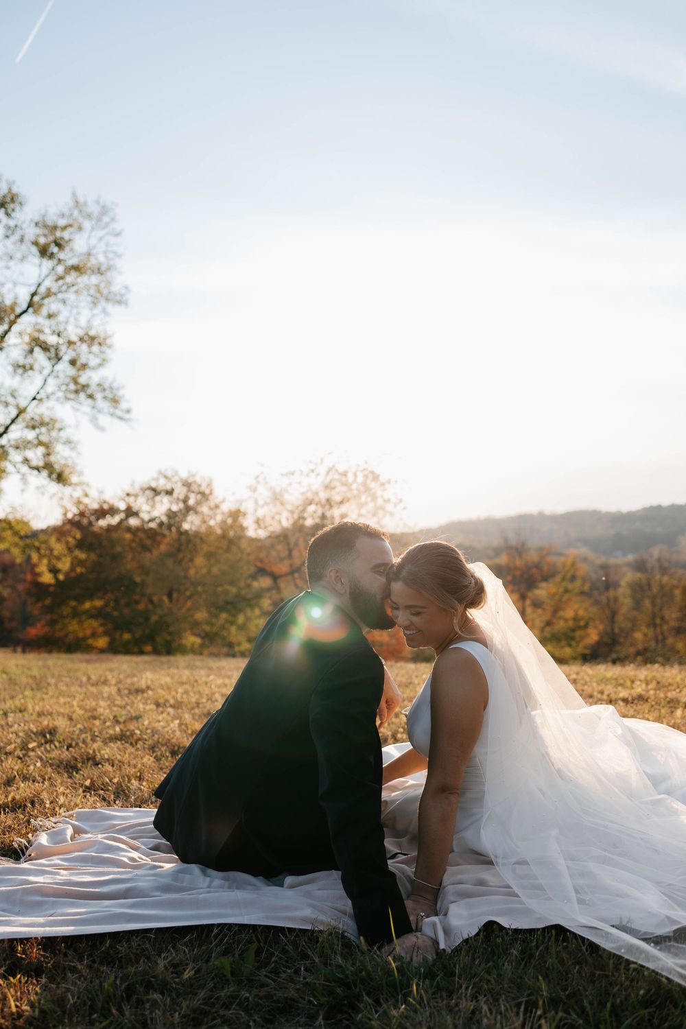 Romantic golden hour wedding kiss between bride and groom in Pittsburgh, PA