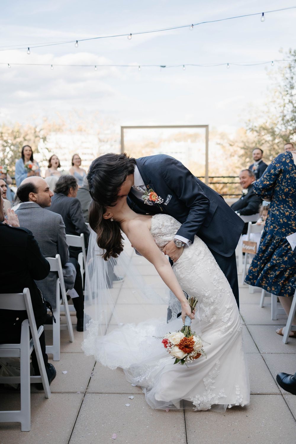 Romantic bride and groom dip kiss captured during outdoor wedding at Hyatt House Southside Pittsburgh