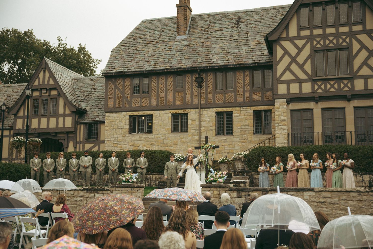 Interior of wooden church with vaulted ceiling and stained glass during wedding ceremony.