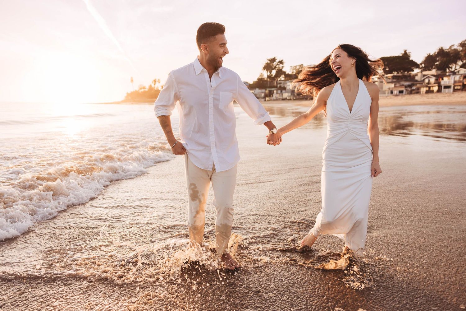 Couple surprise hidden engagement during golden hour with coastal bluffs in Goleta and sunset in the background.