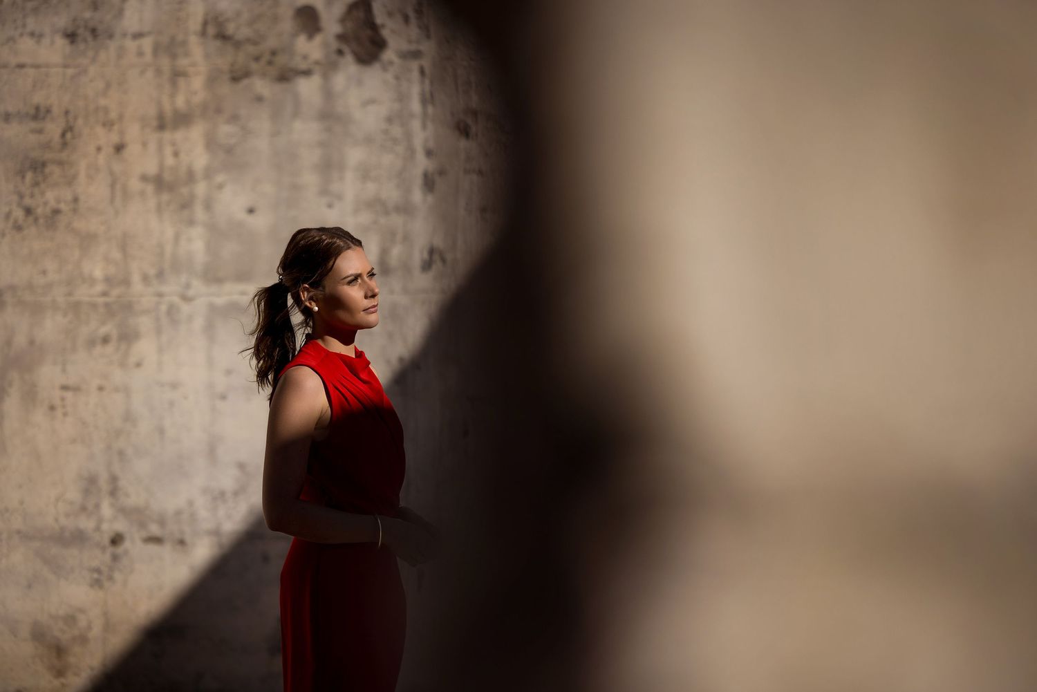 Kirstie Fitzpatrick, weather presenter and Journalist from 7 News Regional wearing a red dress at the Mount Stromlo Observatory ruins.