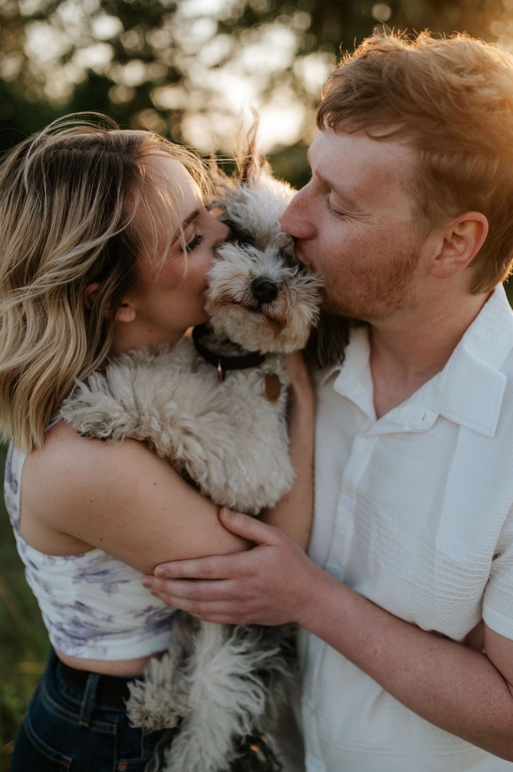 A couple shares tender moments with their small white dog in a series of romantic outdoor photos at sunset.