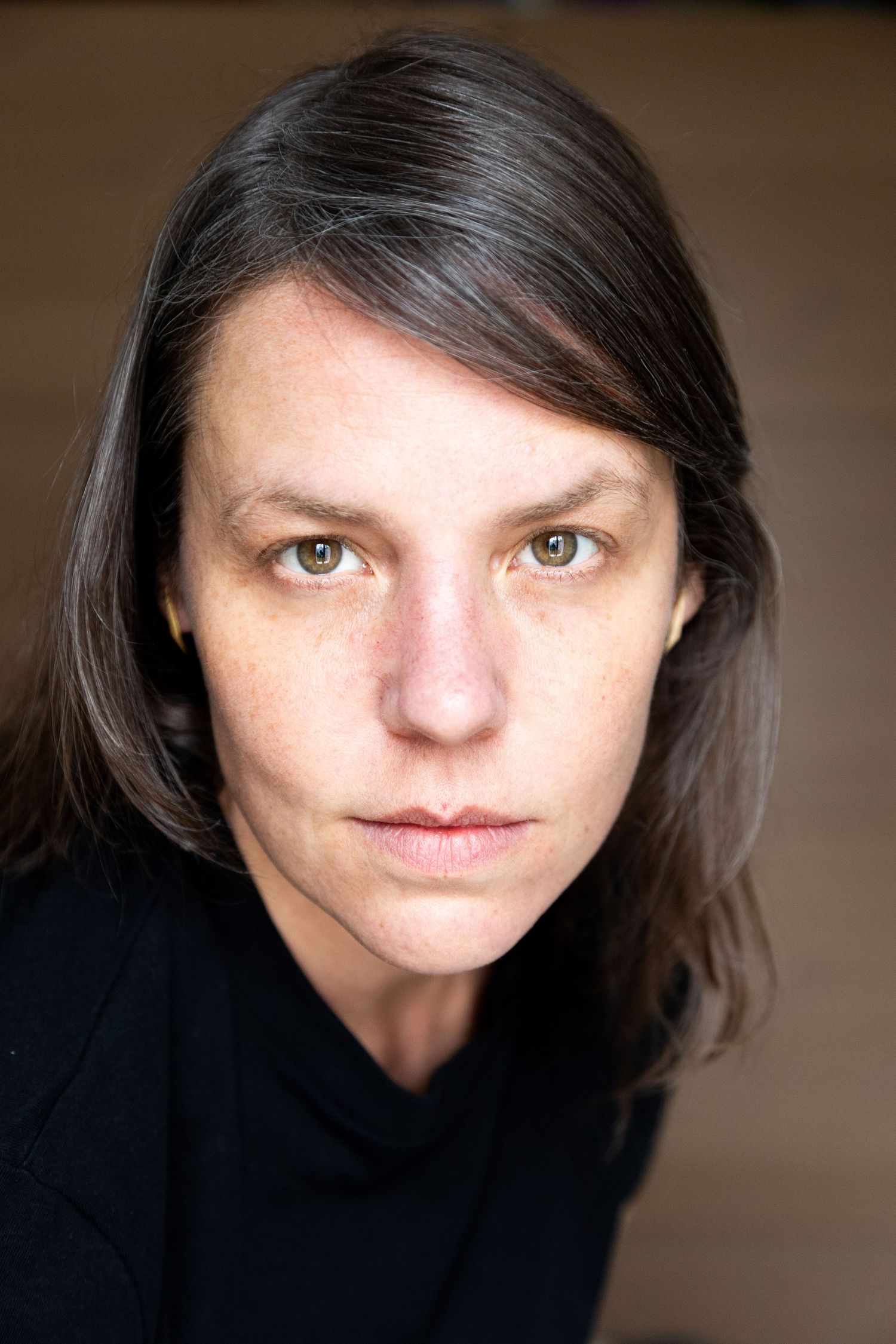 A series of artistic portrait photographs showing different angles and lighting on someone wearing a black shirt.