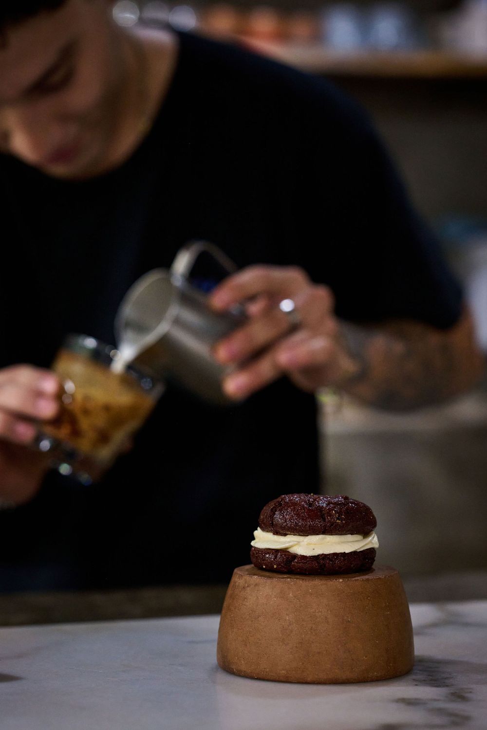 Step-by-step assembly of a chocolate and cream dessert shows layering components on a round base.
