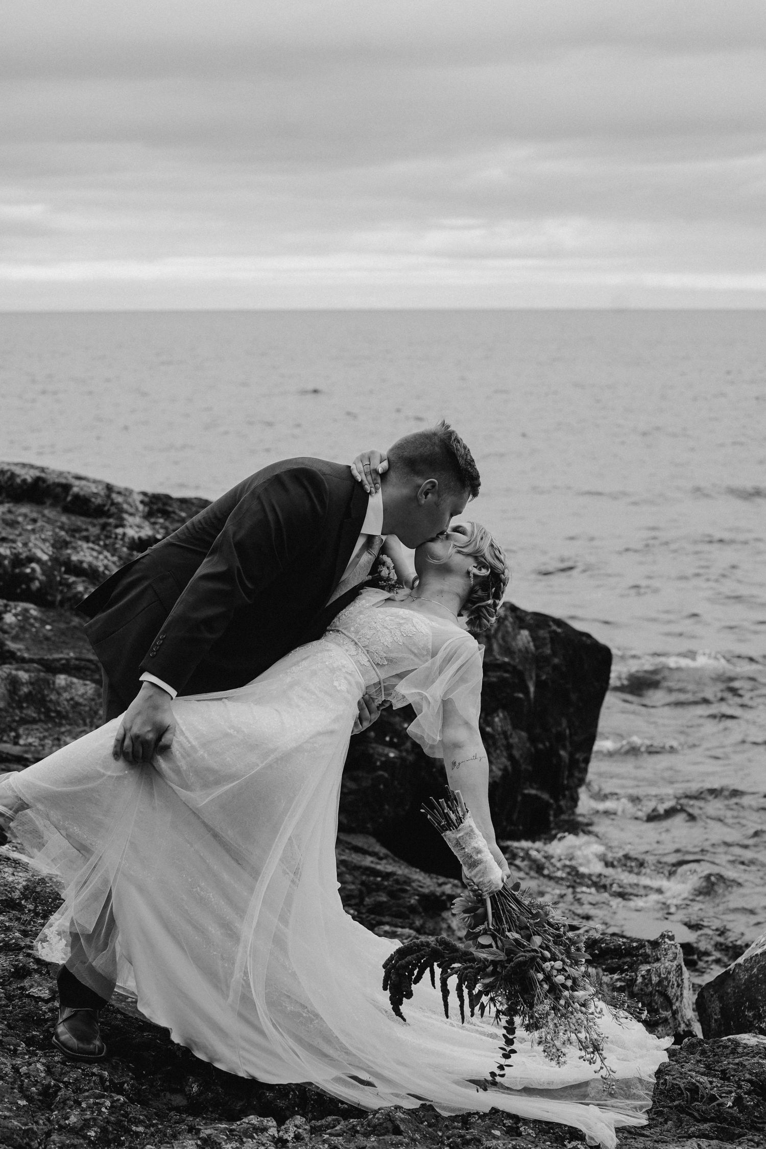 Editorial shot of couple in Tofte Minnesota sharing a kiss at their intimate wedding at Bluefin Bay, Minnesota