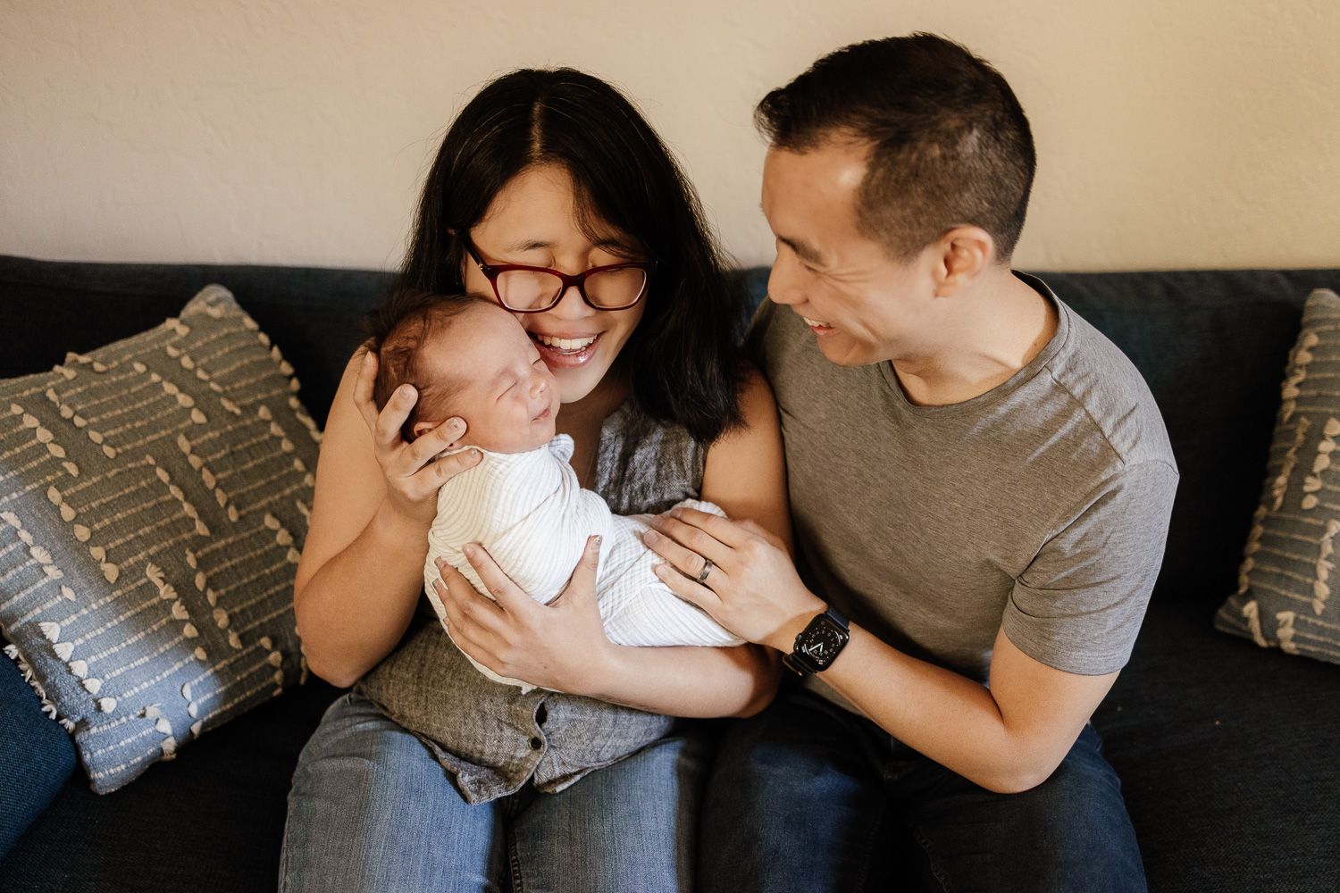 Gentle family snuggles on couch - San Jose newborn photographer