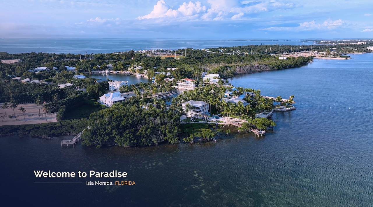 Aerial view of Islamorada, Florida with waterfront homes, lush tropical landscape, and turquoise ocean waters — welcome to paradise.