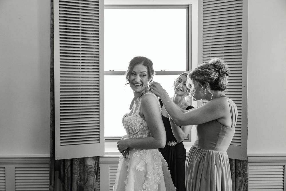 A black and white photo capturing final preparations before the wedding ceremony.