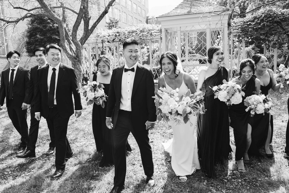 Black and white photo series of a wedding party walking through a garden landscape.