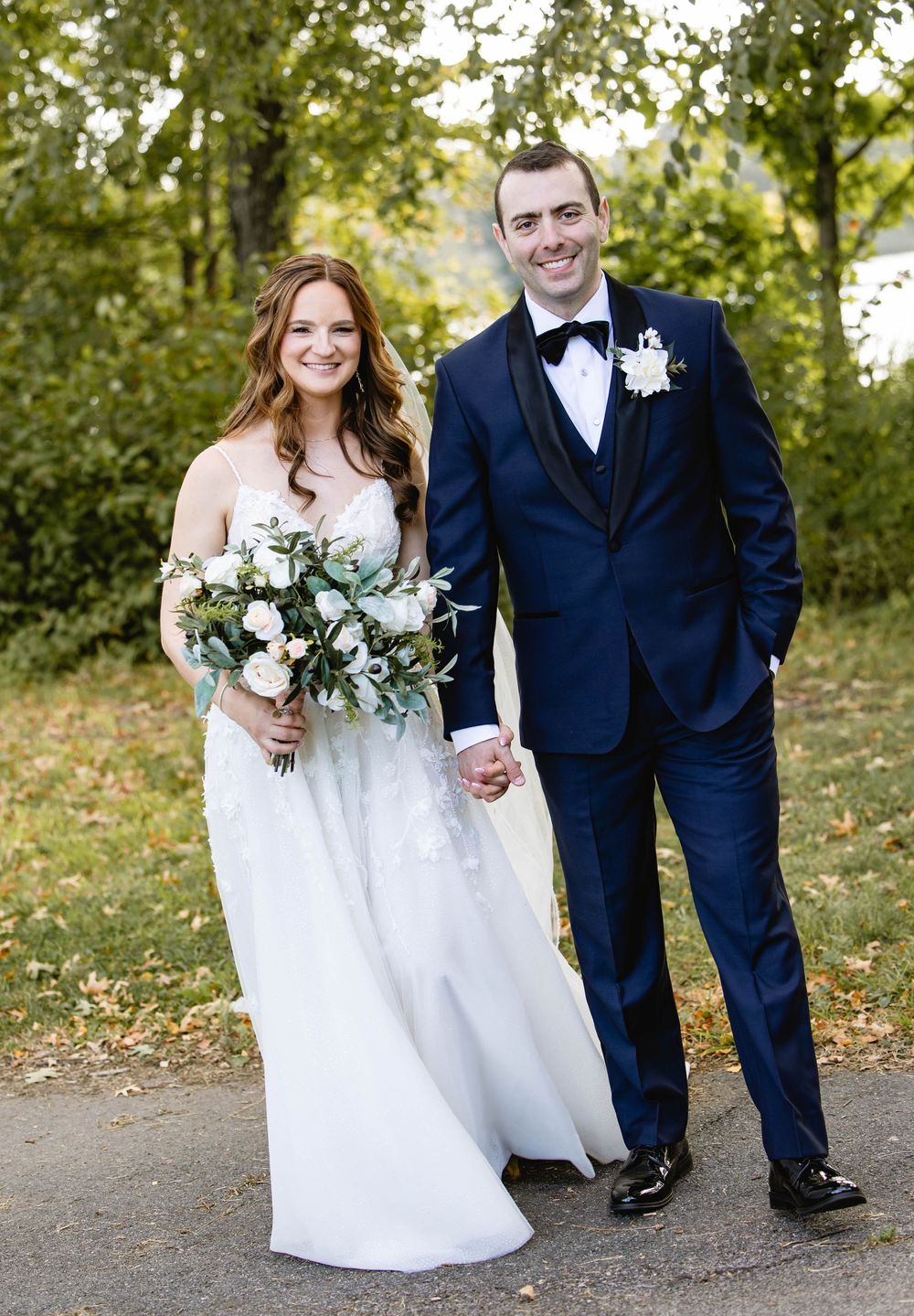 Wedding couple walking together on a tree-lined path in autumn. American Swedish Historical Museum, Philadelphia Wedding.