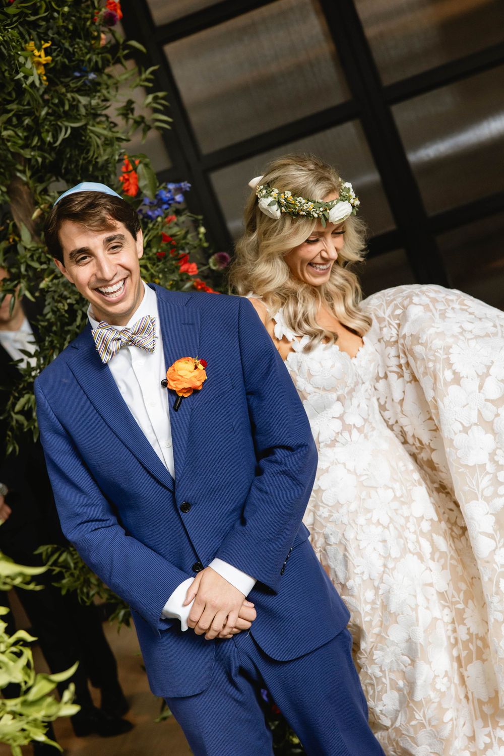 Wedding couple in blue suit and white lace dress posing playfully outdoors. Philadelphia wedding. Switch House Cescaphe.
