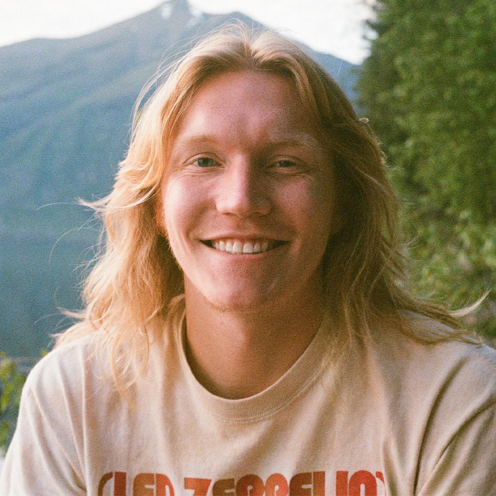 Portrait series against mountain backdrop with natural lighting and casual outdoor setting.