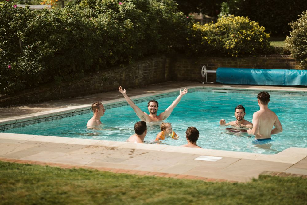 Wedding guests relaxing by the pool at a luxury Surrey wedding venue