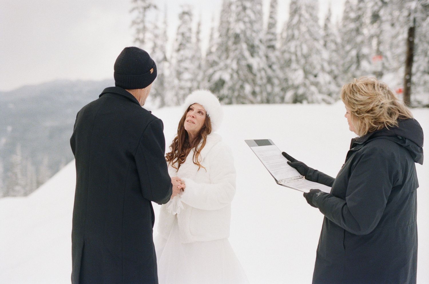 35 mm film photo of bride and groom reading vows during Revelstoke, BC elopement