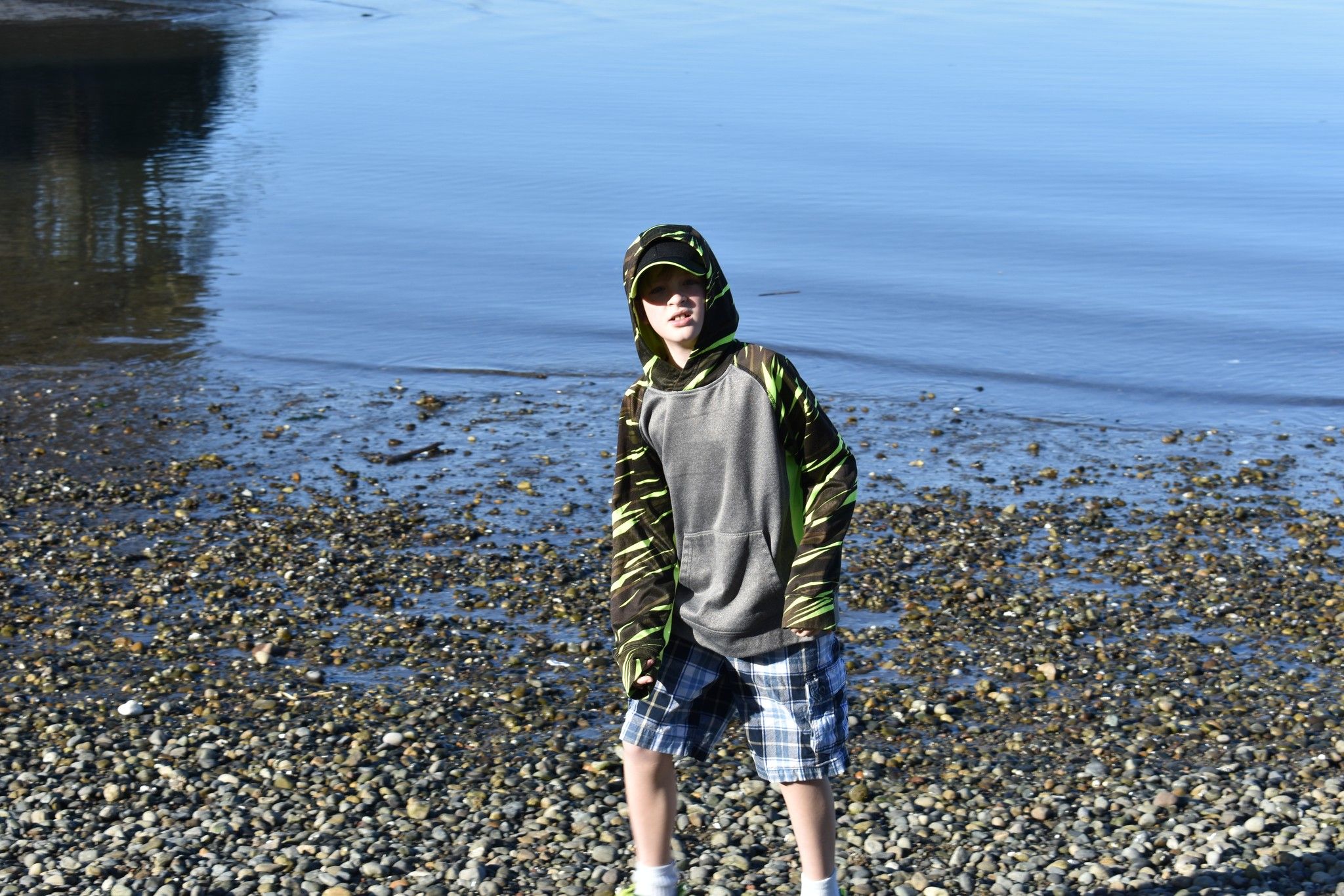 Person standing by the water during a relaxed outdoor lifestyle portrait session