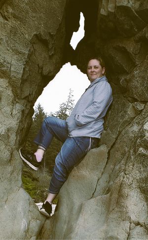 Person standing in a rock formation during an outdoor lifestyle portrait session
