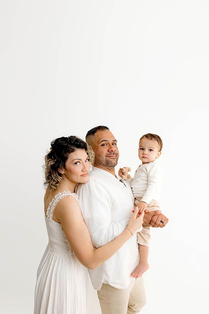 Parents holding their 2 year old son in cute 2nd birthday photoshoot by Menifee photographer.