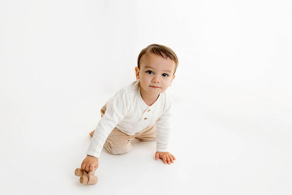 Menifee child photographer photo of little boy's 2nd birthday photoshoot in clean white studio.