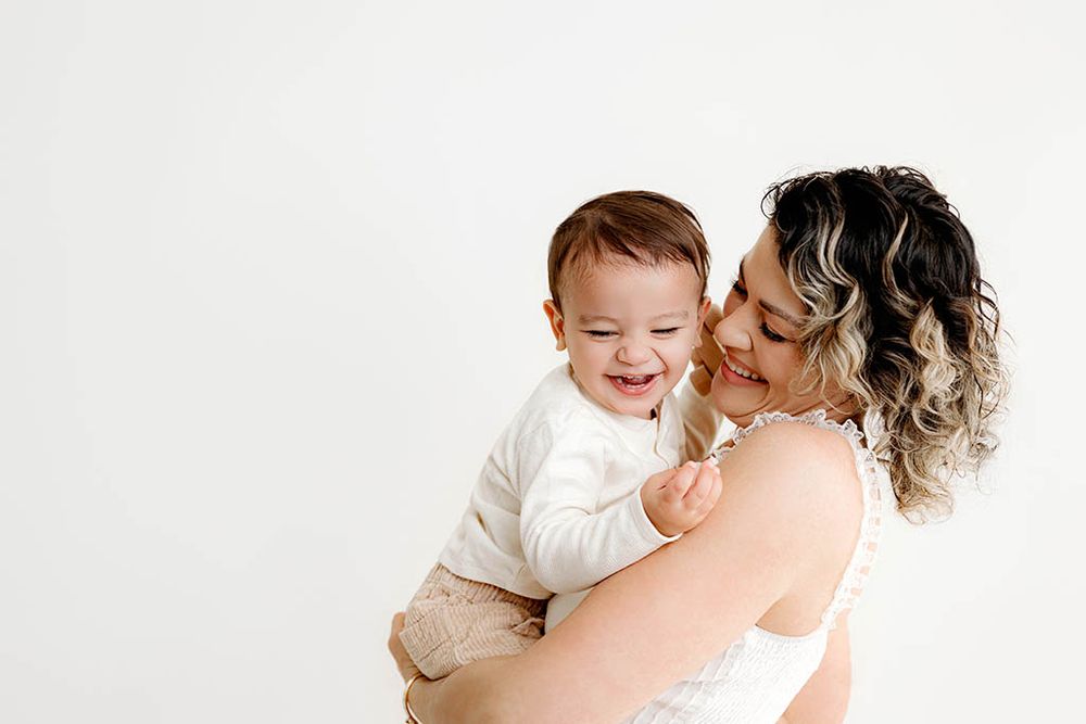 Mom and child against a white background in a bright studio portrait for 2nd birthday photos in Menifee.
