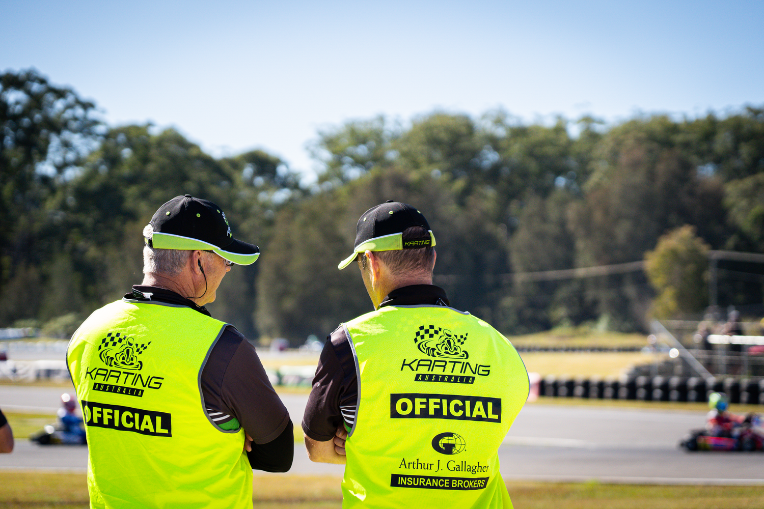 Two volunteer marshals exchange notes after a race