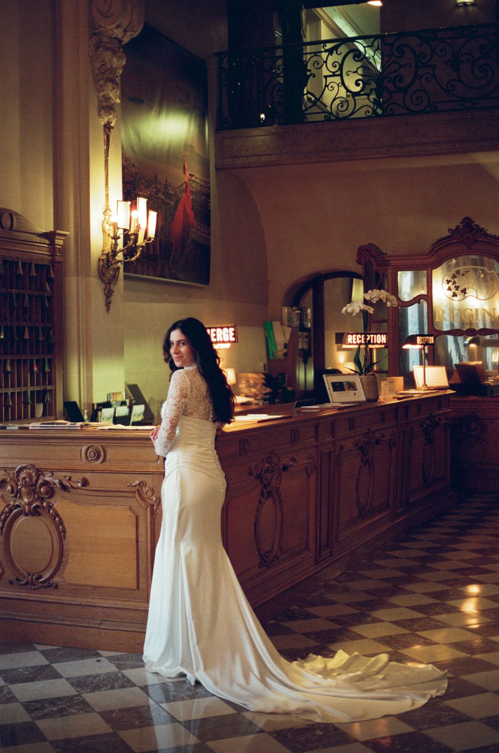 Bride in elegant white lace wedding gown in hotel du louvre. paris bride outfit. paris wedding film photography. paris bride on film 35mm