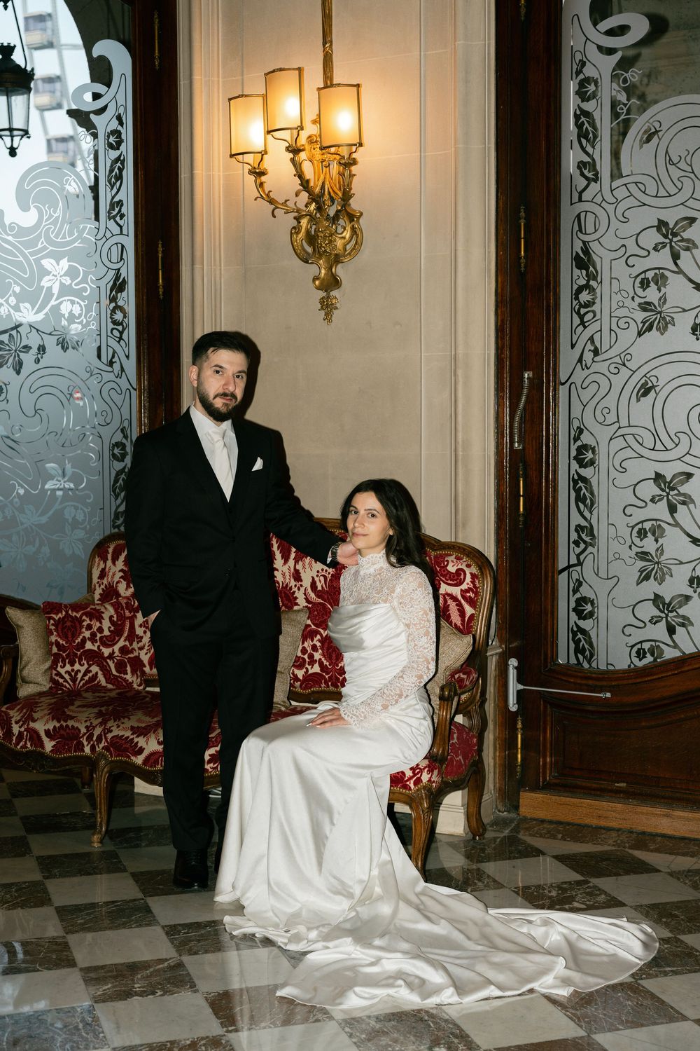 Bride seated on ornate red velvet sofa. Paris hotel wedding locations, best paris wedding photographer, editorial paris wedding photograph