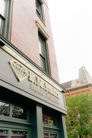 Vintage brick storefront with decorative signage and architectural details.