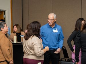 Candid shot of people networking at an indoor business event.