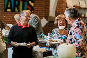 Group enjoying a buffet meal at an indoor event.