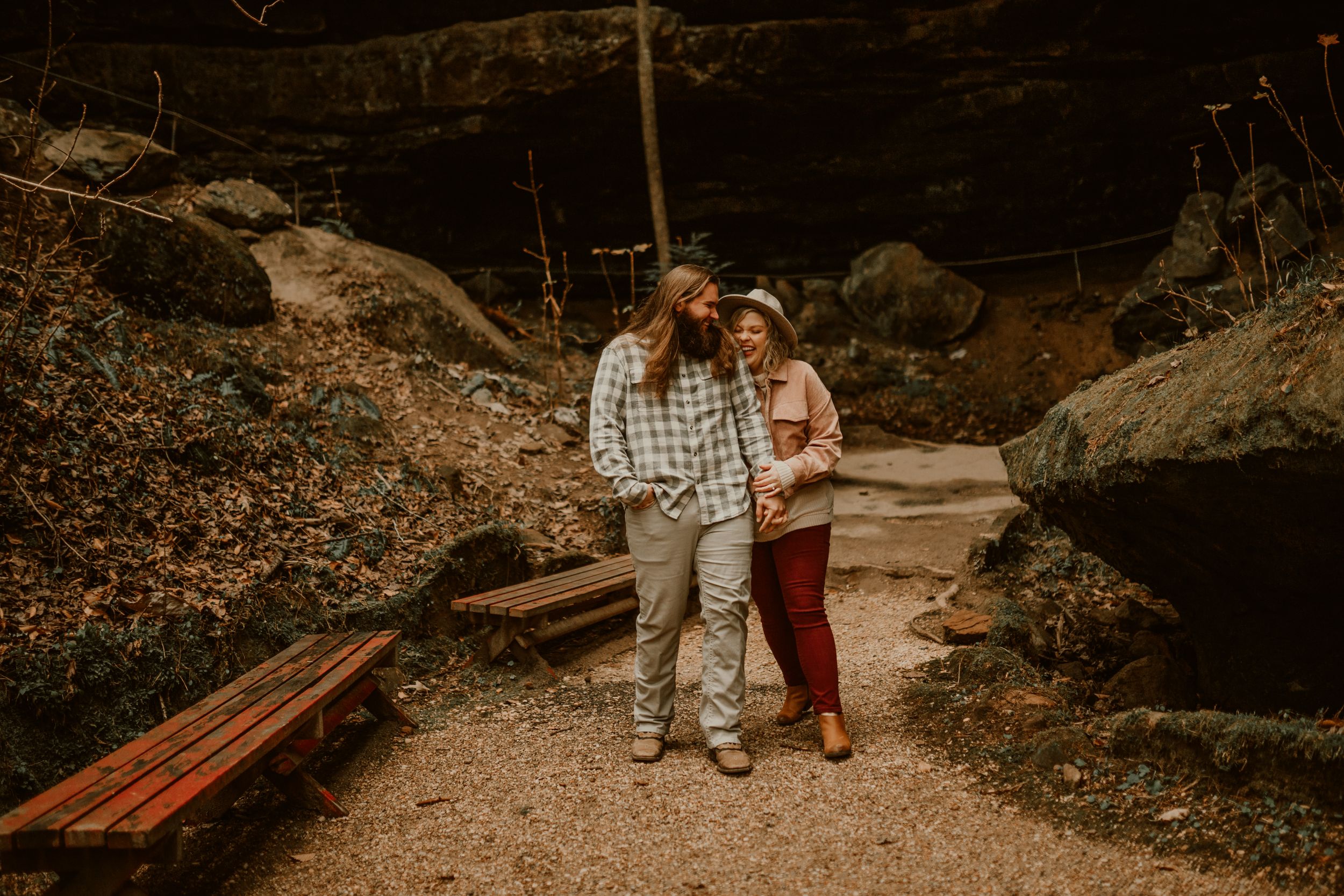 Bashful, sweet couple walking in a rocky terrain.