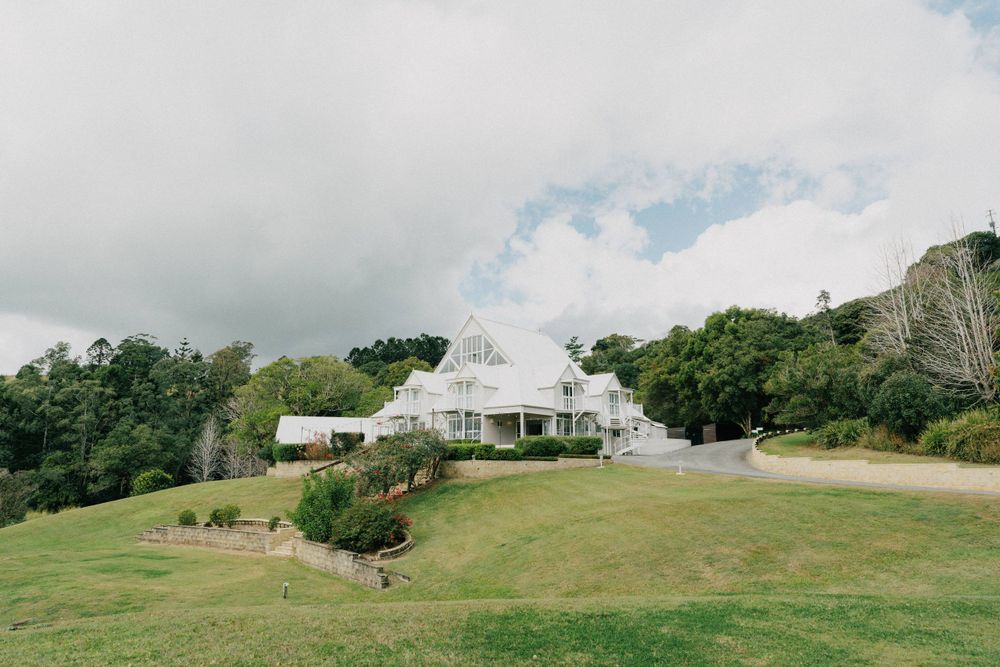 “Groom adjusting his suit before the ceremony at Maleny Manor, captured in a natural wedding photography style.”