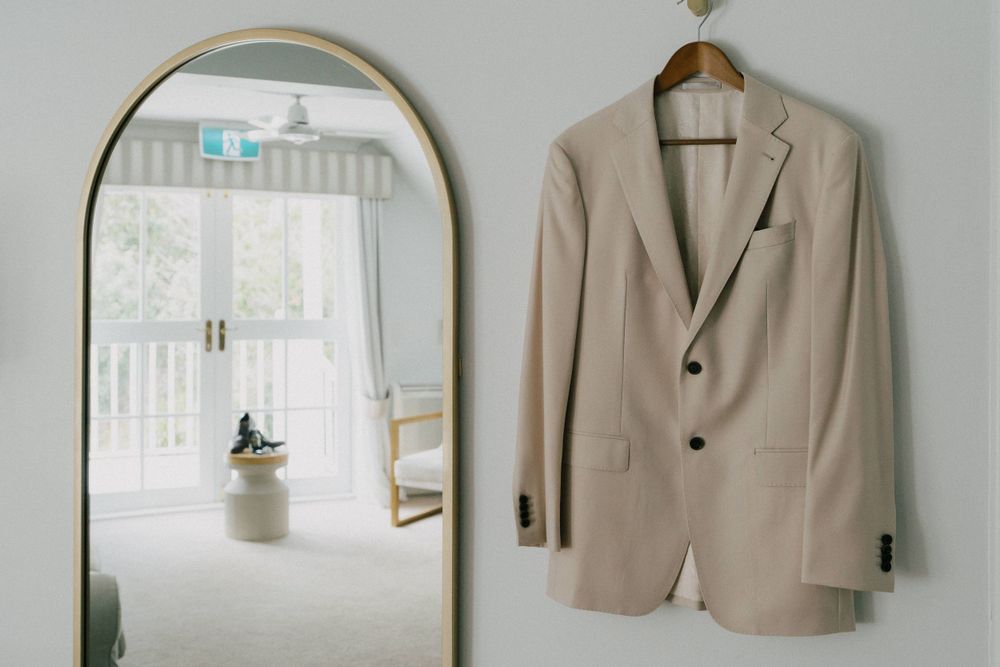 .	“Groomsmen getting ready at Maleny Manor, captured with a candid, natural photography style.”
