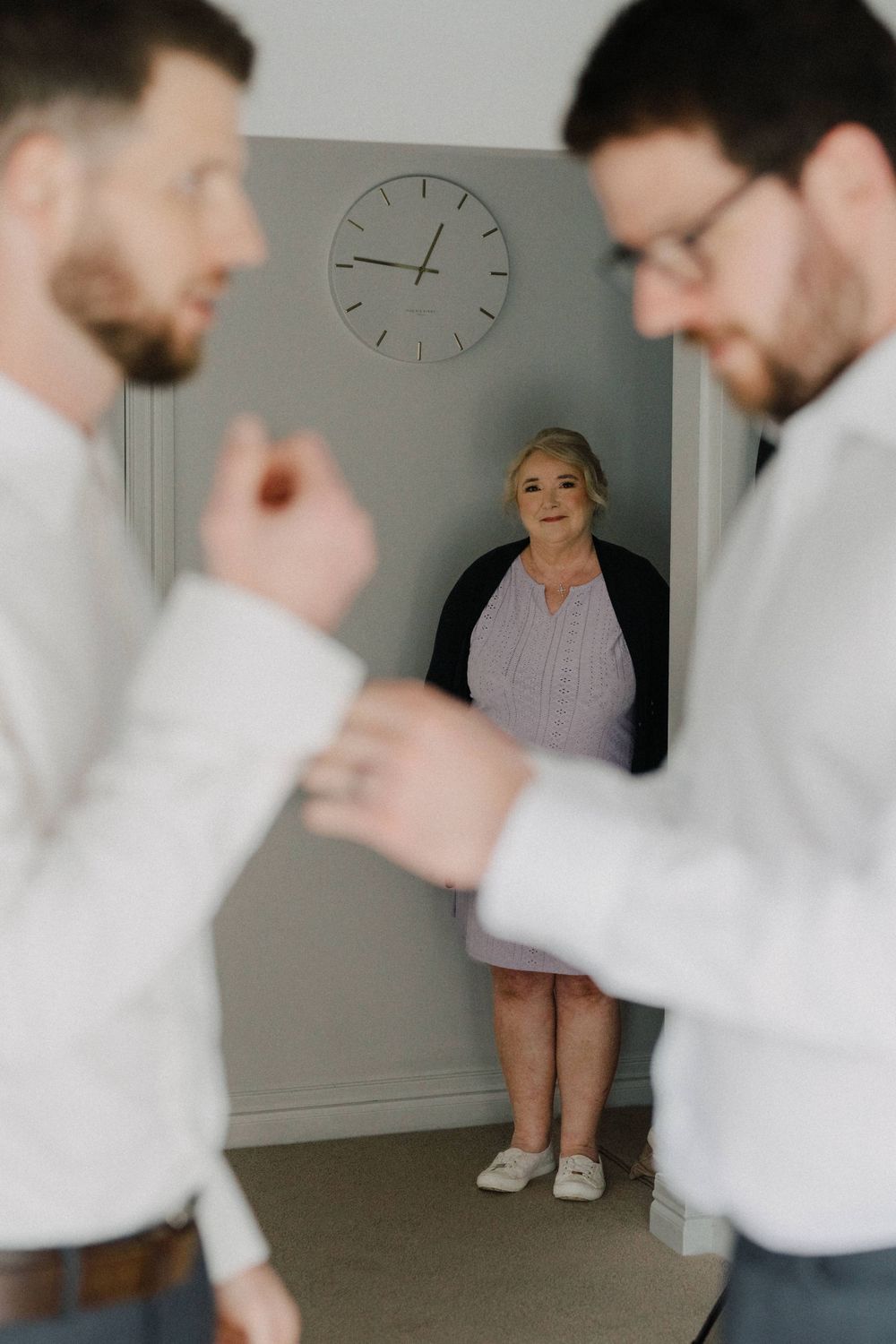 Groom preparing for his wedding day at Maleny Manor, with a breathtaking backdrop, captured in a candid style.”
