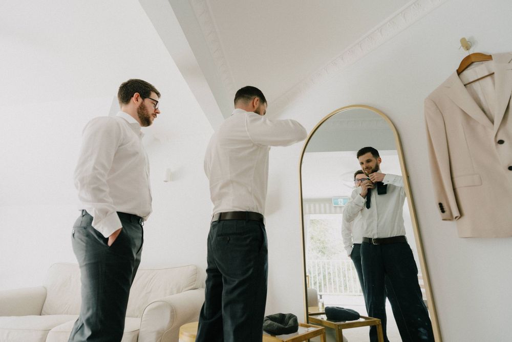“Groom’s final preparations before the ceremony at Maleny Manor, captured in a candid and natural style.”