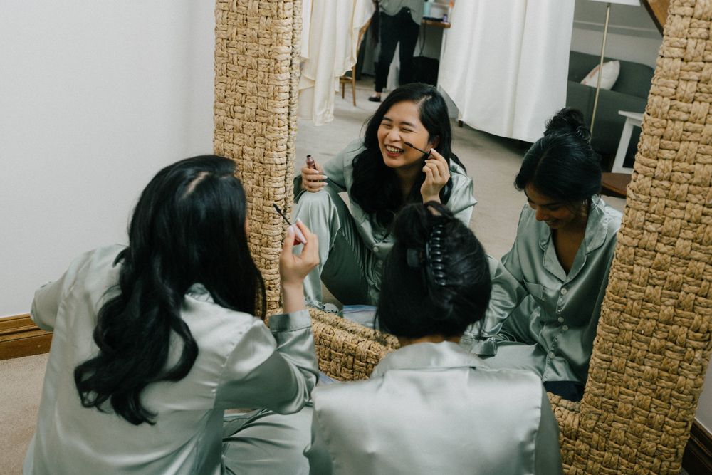 “Bridesmaids laughing and helping the bride get ready at Maleny Manor, captured in a storytelling photography style.