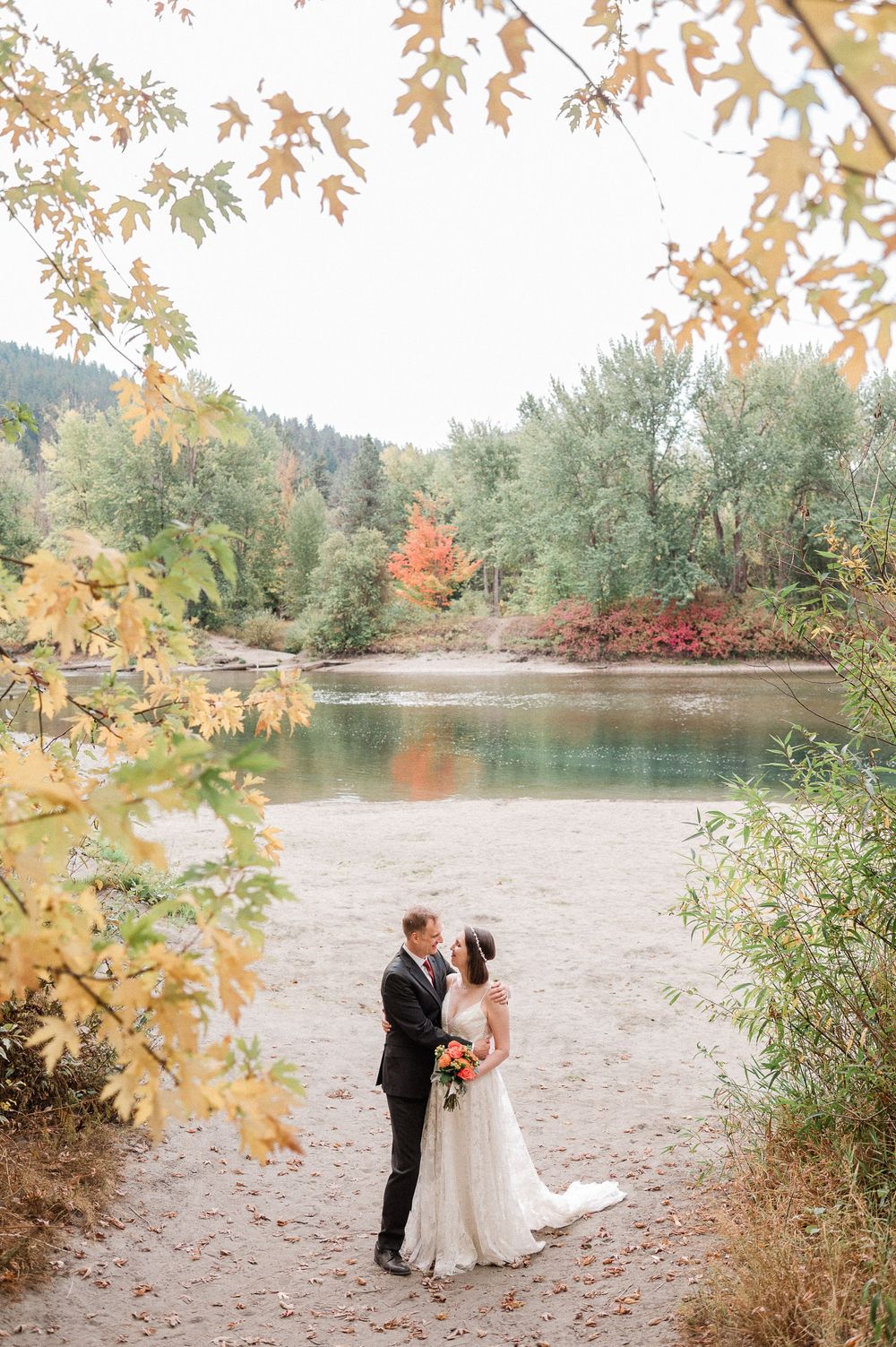 bride and groom surrounded by fall colors during Leavenworth elopement.
