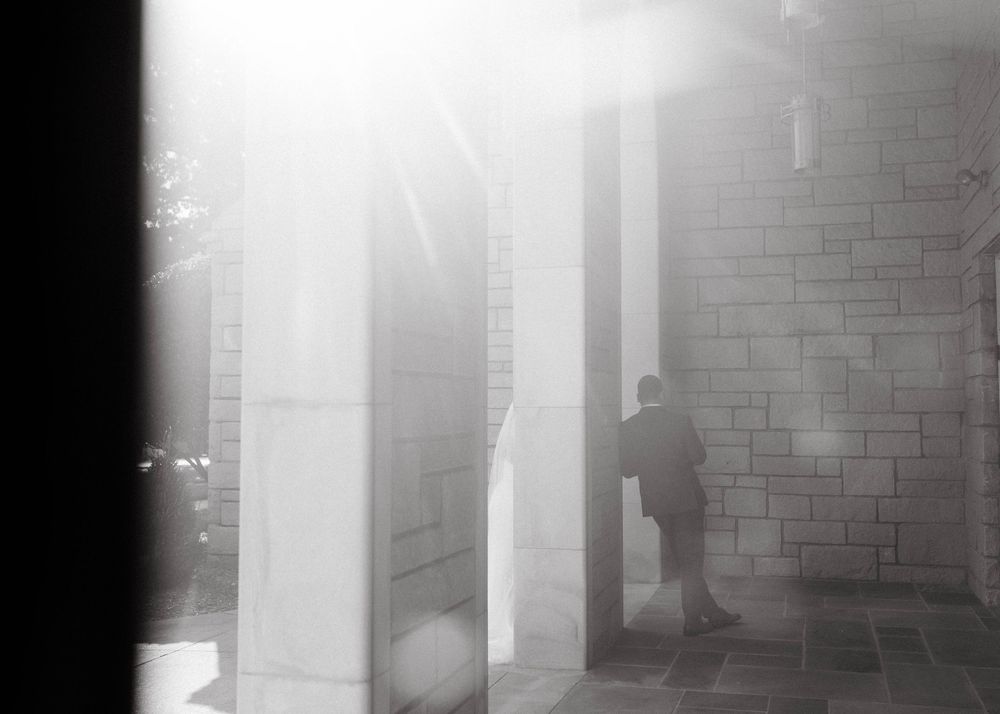 Dramatic black and white film stills showing dark hallways with atmospheric lighting and shadows.