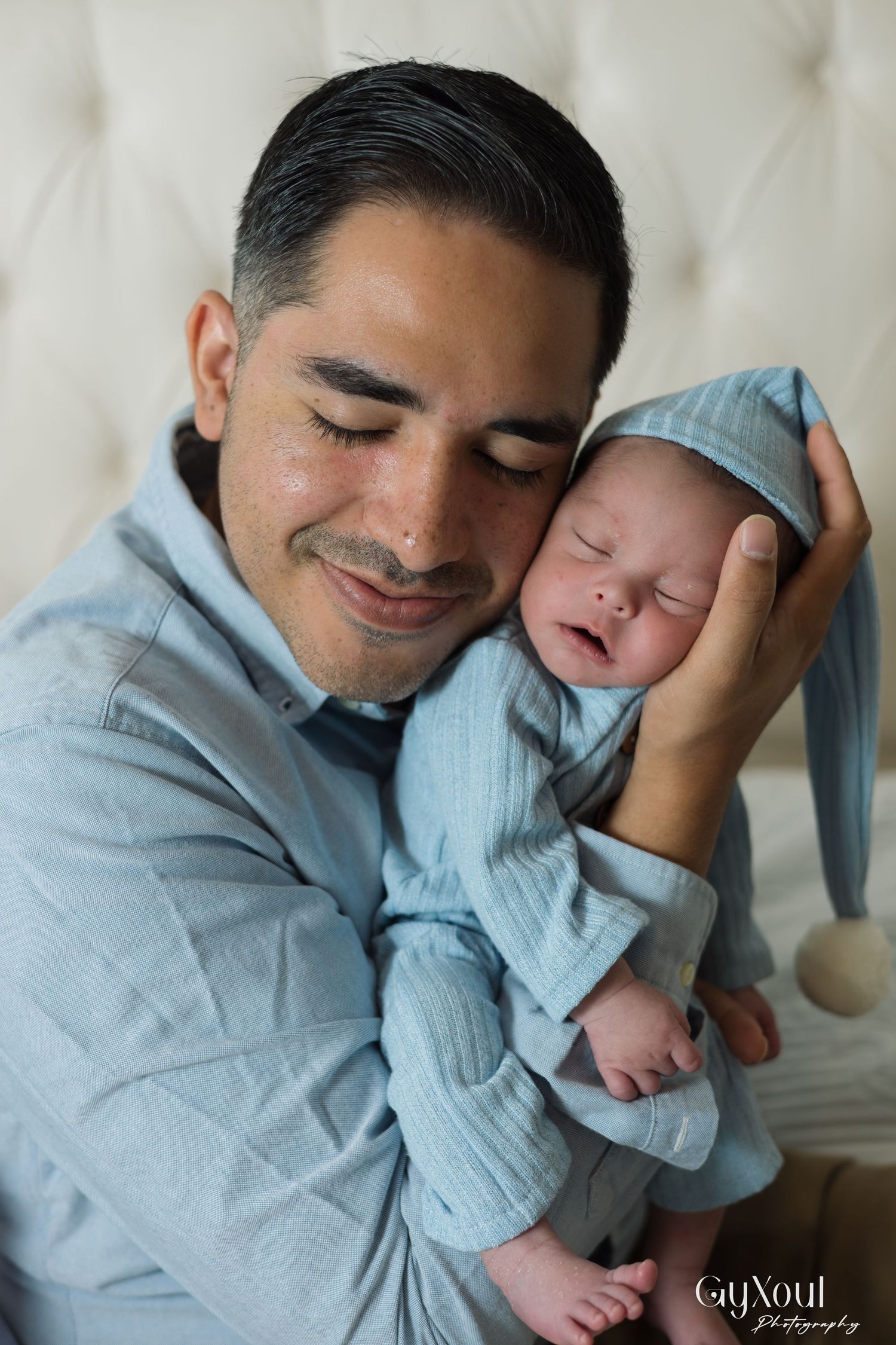 A tender moment captured in a series of photos showing a parent and child embracing in soft blue tones.