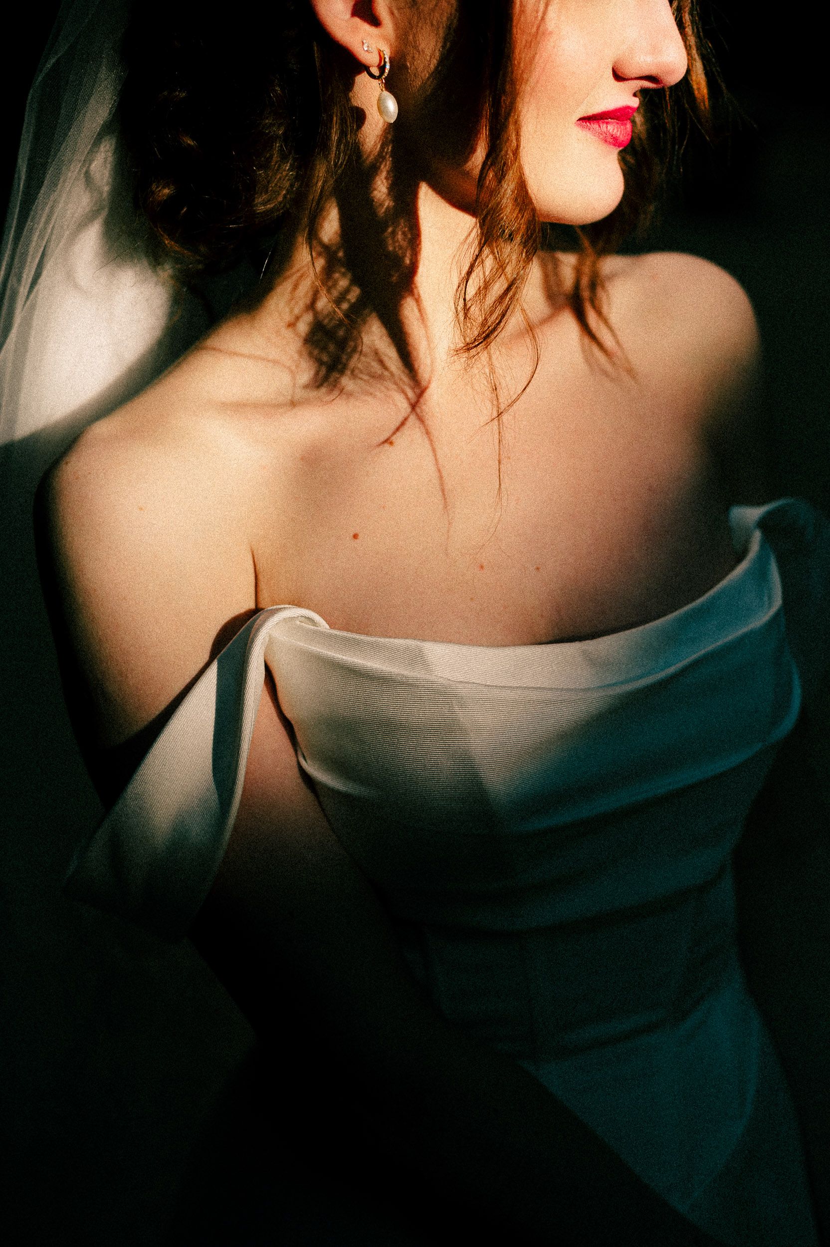 A dramatic series of cropped photos showing red lipstick, bare shoulders, and white fabric in moody lighting.