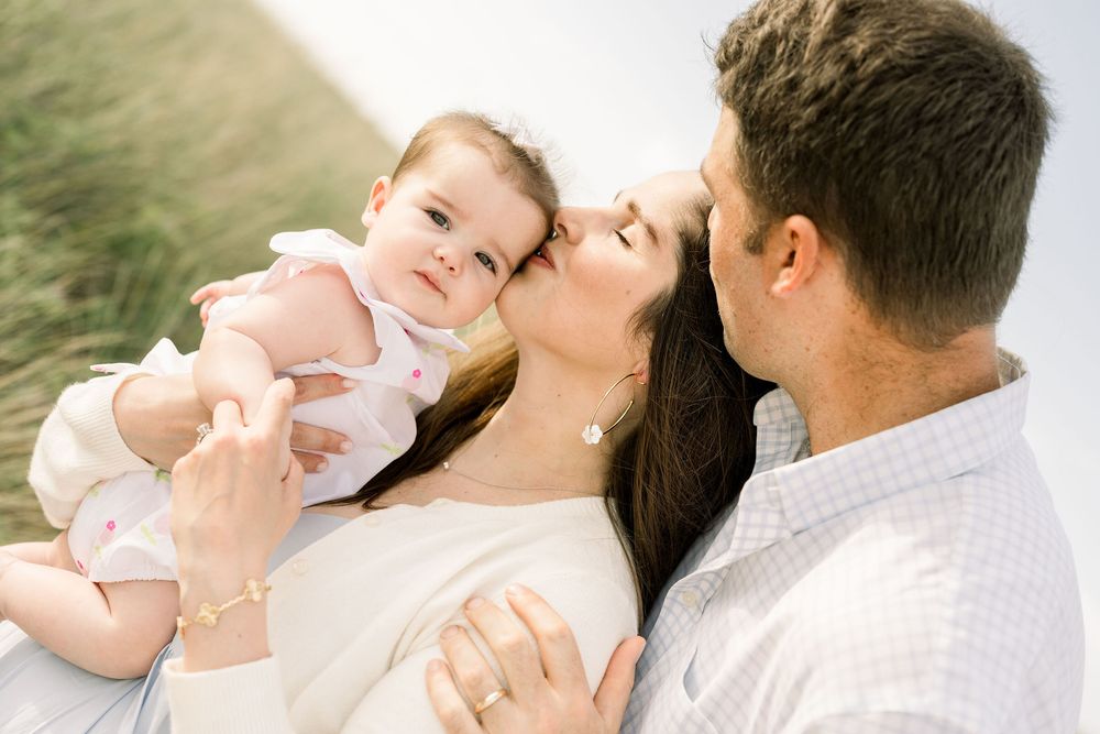 A loving family shares tender moments together outdoors in a series of connected photos showing affection and joy.