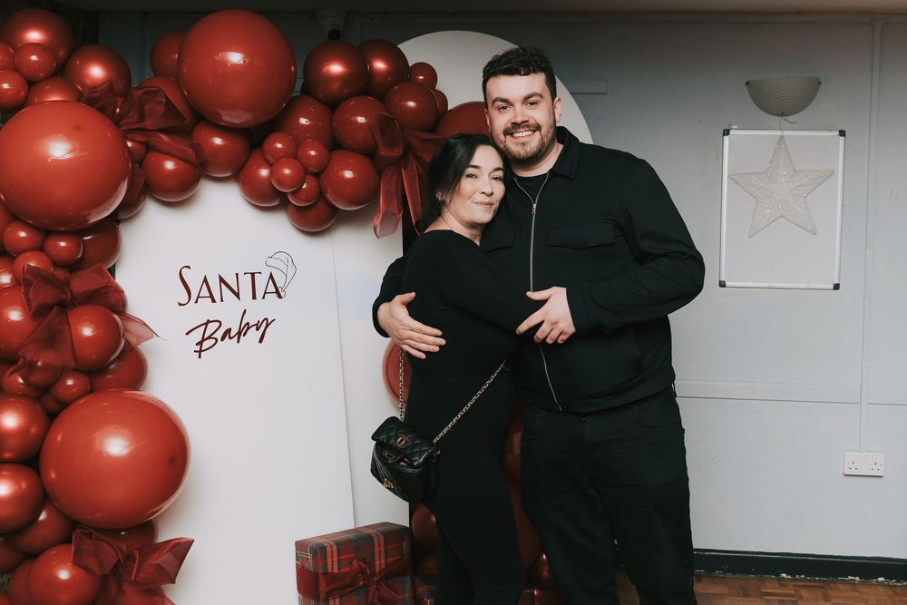 Candid baby shower party photos showing red balloon arrangements and holiday decorations in a brick-walled room.