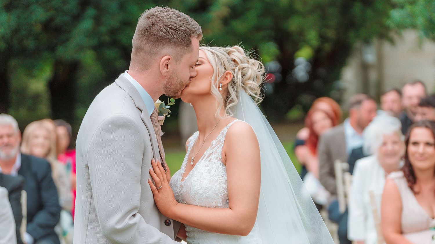 A couple shares their first dance together at their wedding reception in a bright indoor venue.