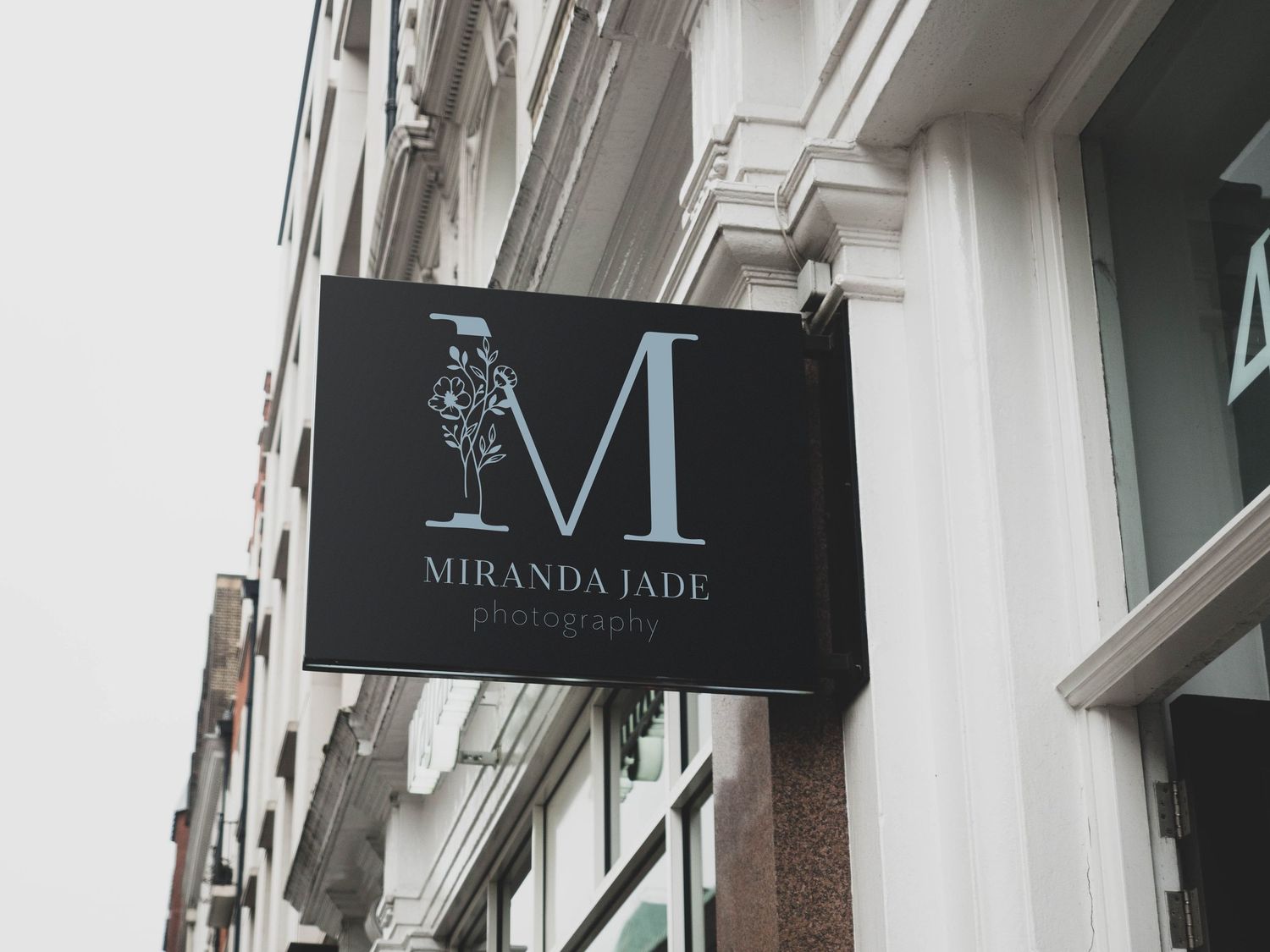 Elegant storefront with white facade and black signage displaying Miranda Paris branding.