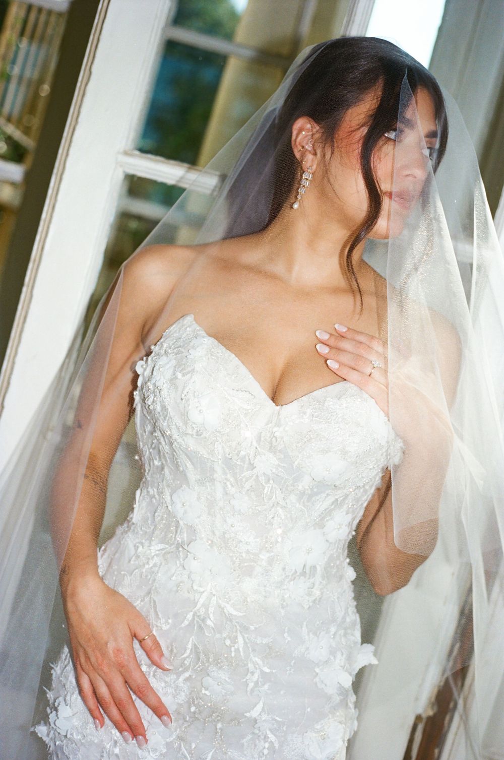 Multiple angles of a bride in a detailed lace wedding dress with sweetheart neckline and long veil.