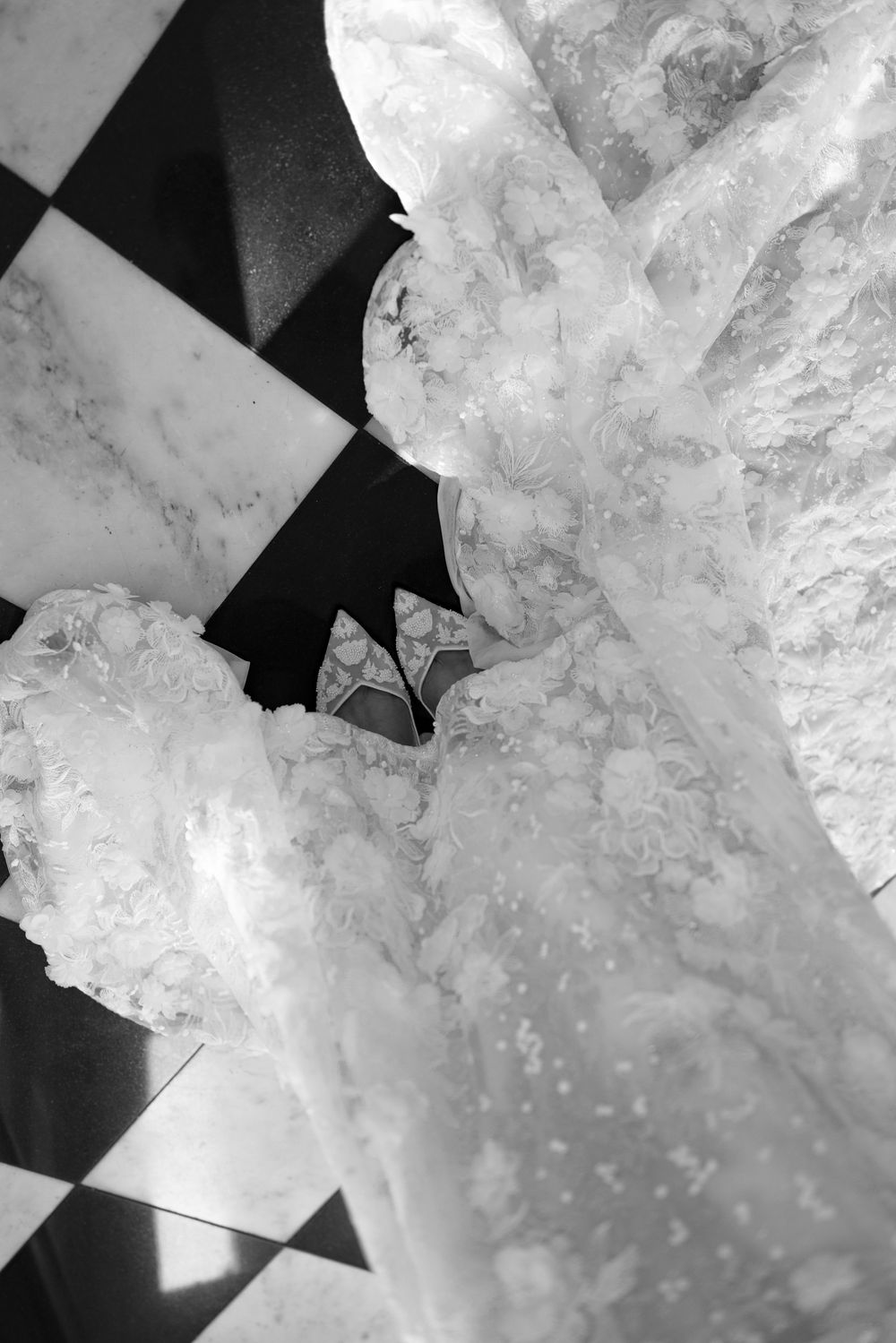 Abstract close-up details of intricate white lace wedding dress fabric.