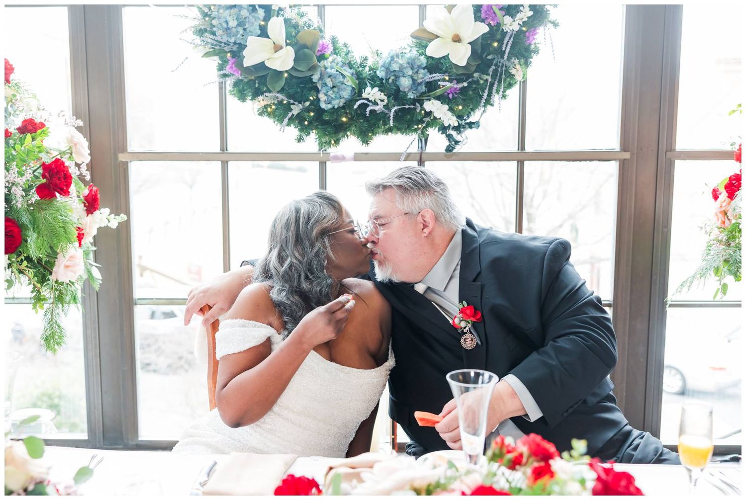 Wedding reception guests enjoy conversation and drinks at elegantly decorated tables.