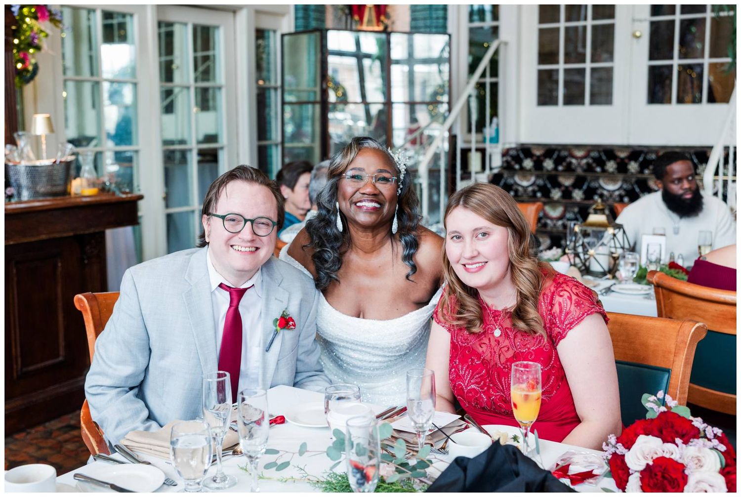 A group of people enjoying a celebratory meal at a restaurant with red and white decor.